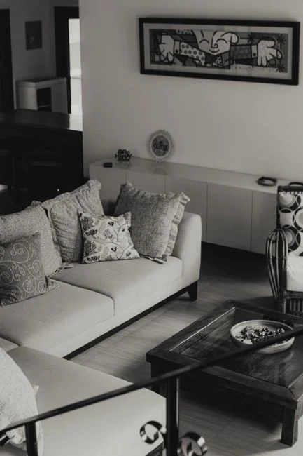 Young couple assembling furniture in their new apartment, surrounded by cardboard boxes.